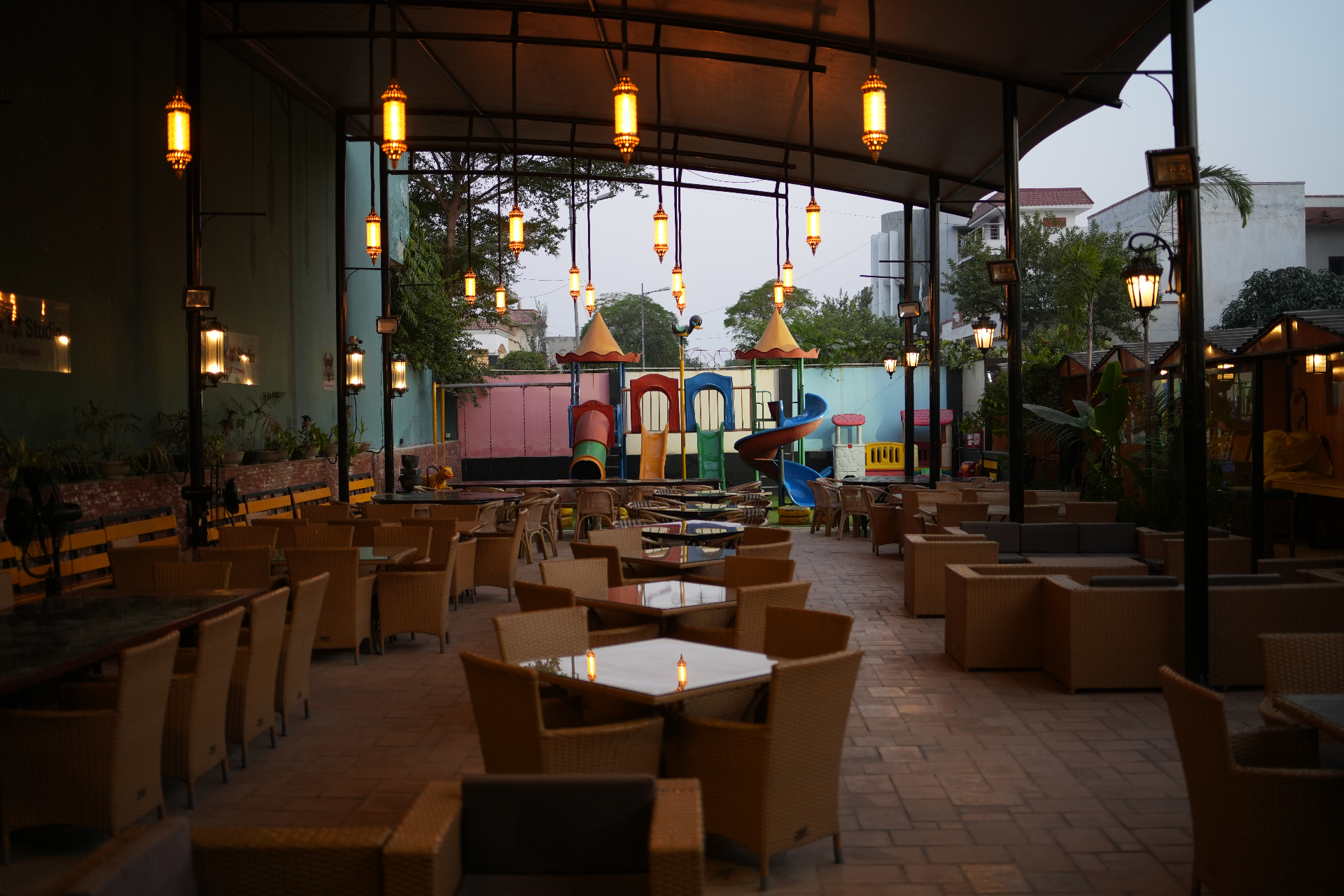 Steak Studio Canal Bank Rd. backyard garden with lantern lighting and kids' play area
